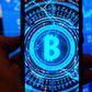 A multiple exposure image shows a Bitcoin logo displayed on a smartphone with stock market percentages in the background