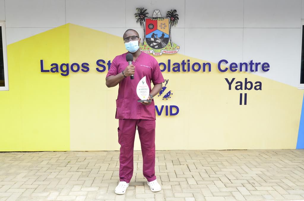 Dr. Ayodeji Anthony Falana holding his award plaque as the most outstanding health worker in the fight against COVID-19 during an event by 9mobile to recognize health workers at the frontline of the current COVID-19 pandemic.