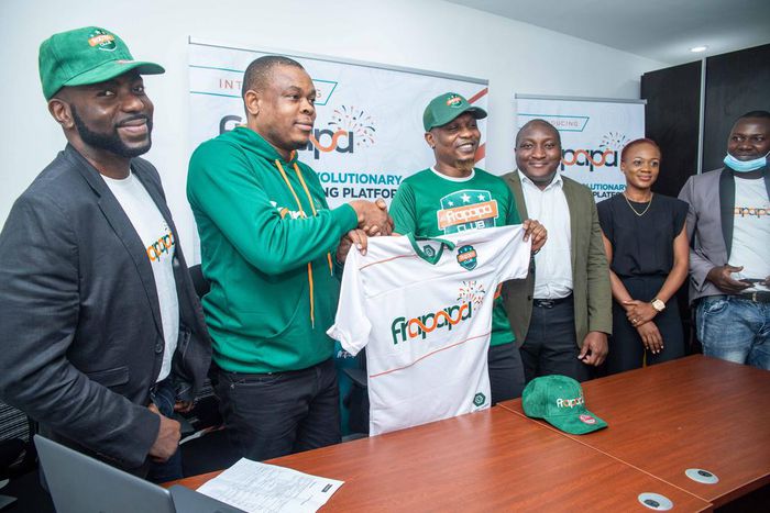 L-R: Charles Dungor, Chief Marketing Officer of Soloti Gaming Limited holding a Jersey with the Chief Frapster, Reminisce