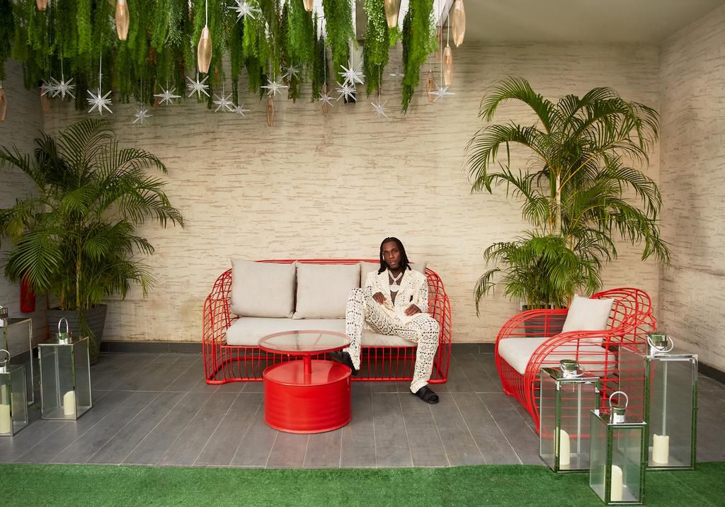 Burna Boy poses in his home for Architectural Digest
