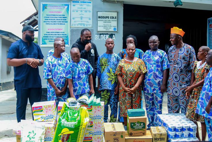 L-R Stephen Chibuzor. PR Manager (Nigeria) Boomplay, Mr Dele Kadiri. GM (Nigeria) Boomplay, handing over the donations to Mr Ajani, Vice principal Modupe Cole Memorial School.