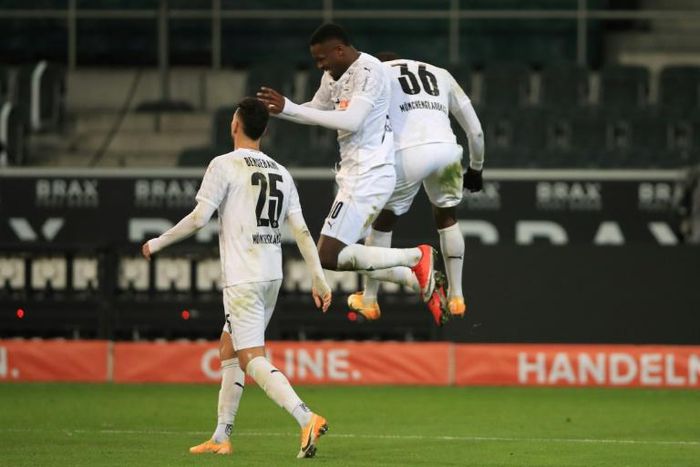 Marcus Thuram (C) celebrates scoring for Borussia Moenchengladbach in Friday's 4-2 win over Dortmund