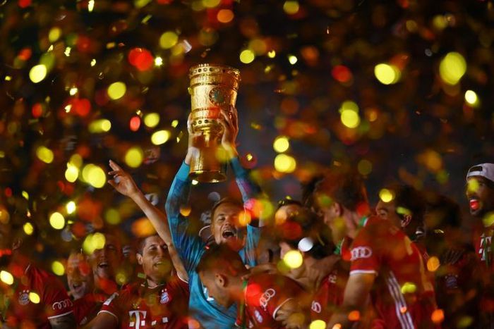 Manuel Neuer raises the German Cup trophy after Bayern Munich beat Bayer Leverkusen in last season's final in July