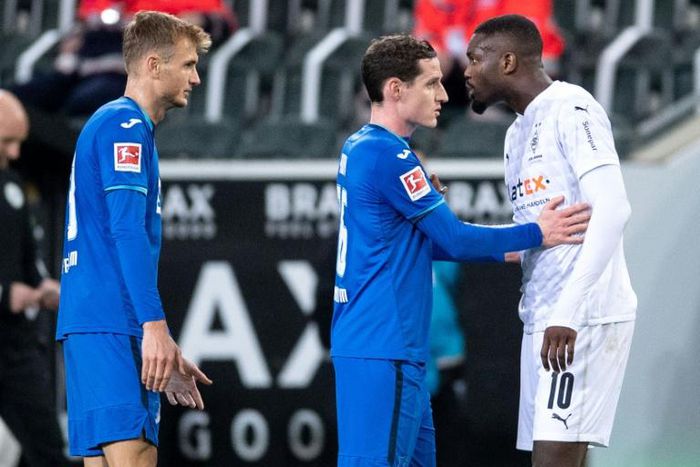 Hoffenheim's Sebastian Rudy separates Marcus Thuram from Stefan Posch