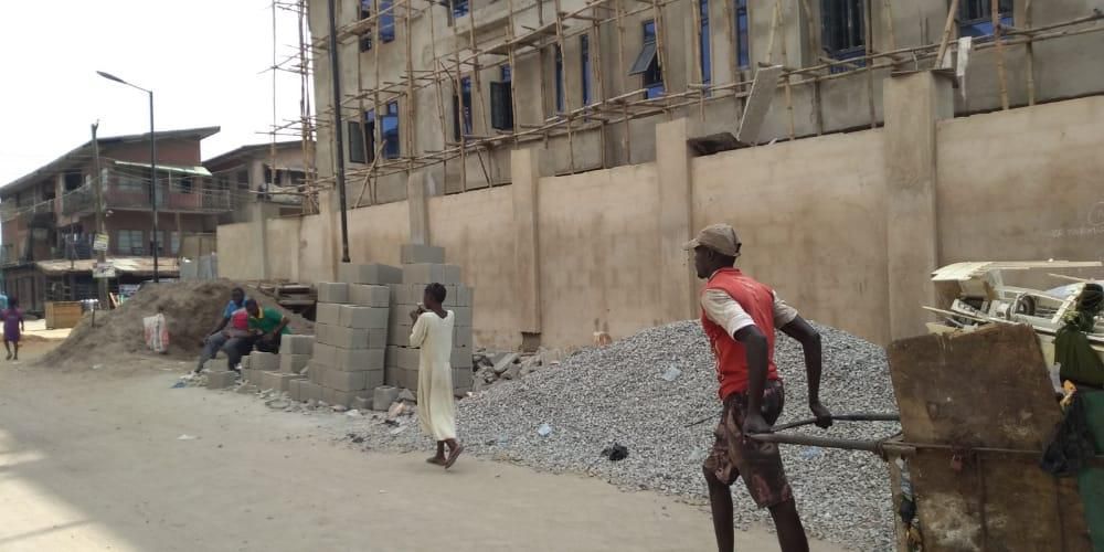 Building materials kept on the road in Ebute Metta in violation of Lagos laws. (Pulse)
