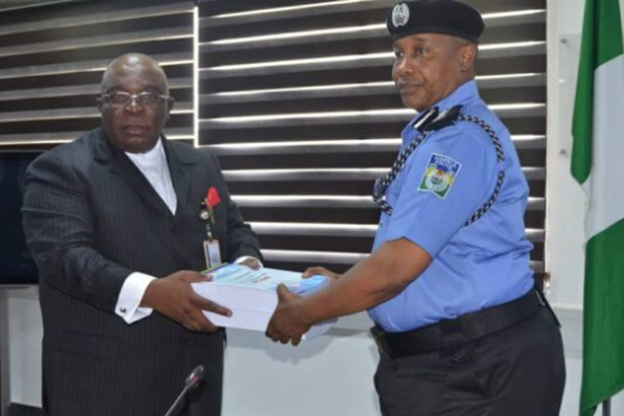 The chairman of the SIP, DIG Joseph Egbunike submitting panel report on Abba Kyari-Hushpuppi scandal to IGP, Usman Baba. (The Cable)