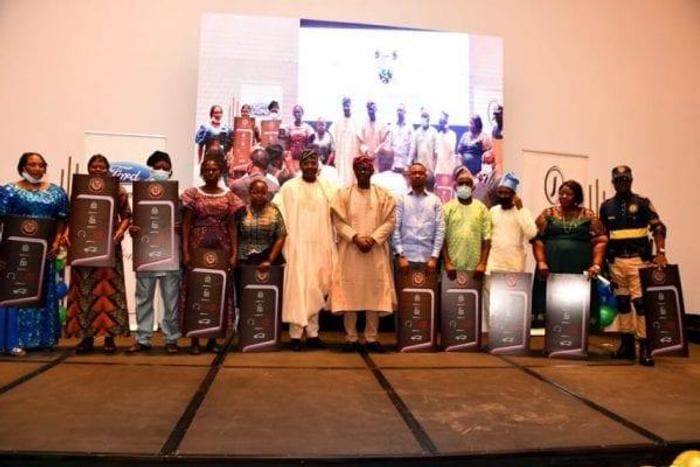 L-R: Lagos State Governor, Mr Babajide Sanwo-Olu (6th right) flanked by Head of Service, Mr Hakeem Muri-Okunola (6th left) in a group photograph with winners of car gift at the Luncheon with 2019/2020 outstanding officers (Junior & Senior Categories) i...