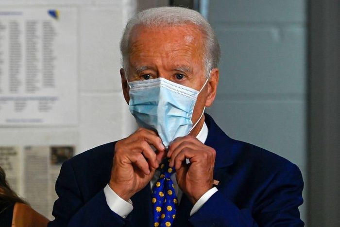 Former Vice President Joe Biden puts on a mask after a campaign event on July 28, 2020.