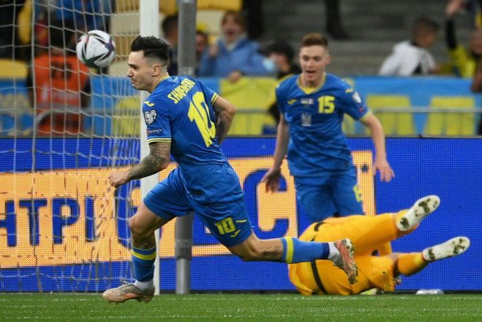 Mykola Shaparenko (L) wheels away in celebration after scoring for Ukraine