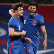 England defender Harry Maguire (L) celebrates with Tyrone Mings