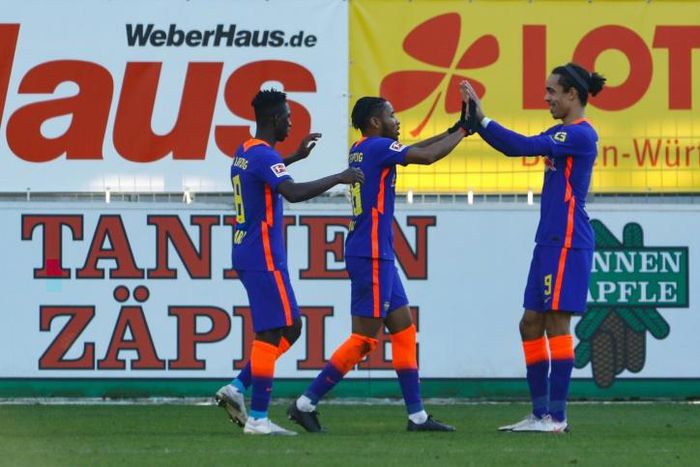 Christopher Nkunku (C) celebrates scoring for RB Leipzig at Freiburg on Saturday