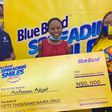 Beneficiary flanked by Olufemi Osobe , Head of Sales and Titilope Reju, Brand Manager, Blue Band Nigeria