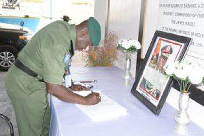 The GOC 1 Division Nigerian Army,Kaduna , signing condolence register of Late COAS Lt-Gen Ibrahim Attahiru other officers involved in plane crash on May 21 in Kaduna. [NAN]