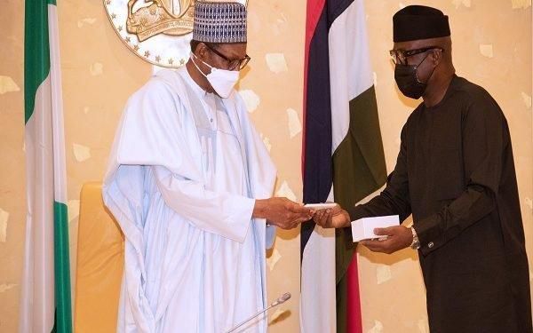 President Muhammadu Buhari receives first made in Nigeria cell phone. [The Nation]