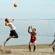 People playing volleyball at the beach