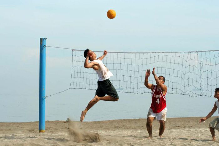 People playing volleyball at the beach