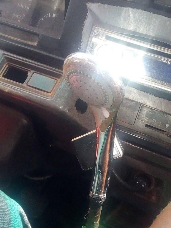 Trotro driver uses showerhead as a gear stick knob for the rickety vehicle