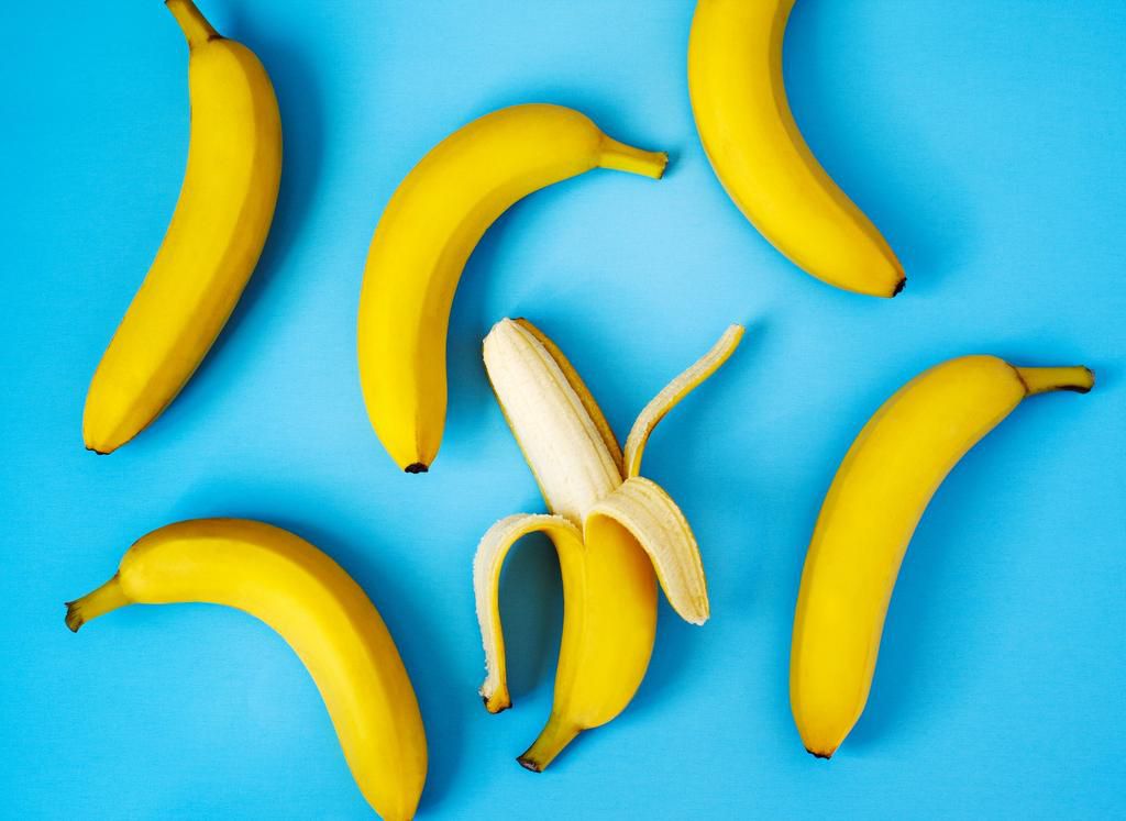 Ripe bananas on blue background