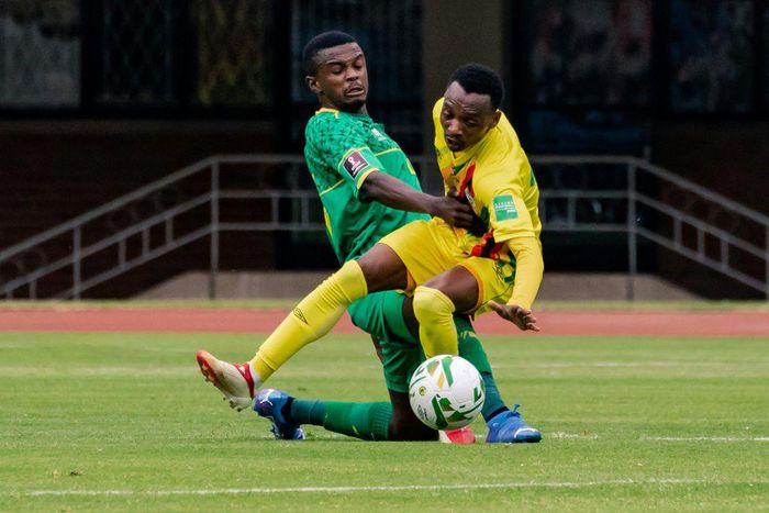 Zimbabwe forward Khama Billiat (R) contests possession with South Africa midfielder Teboho Mokoena (L) during a 2022 World Cup qualifier in Harare