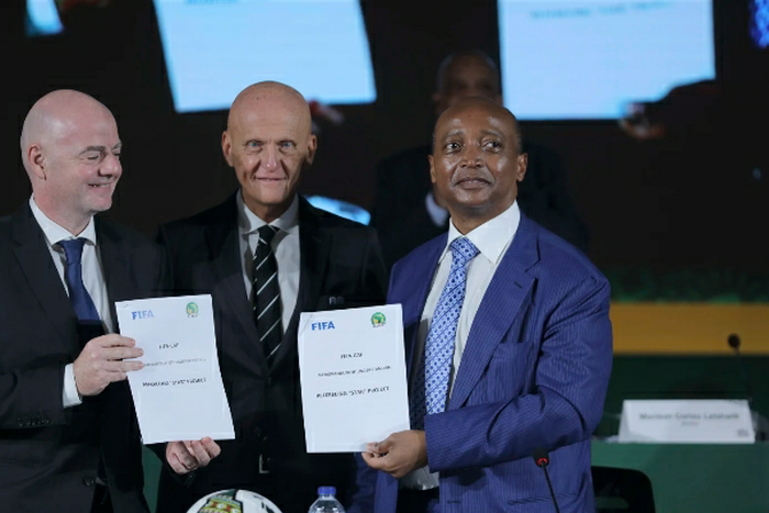 FIFA Chairman of Referees, Pierluigi Collina, with the Presidents of FIFA and CAF display the MoU.
