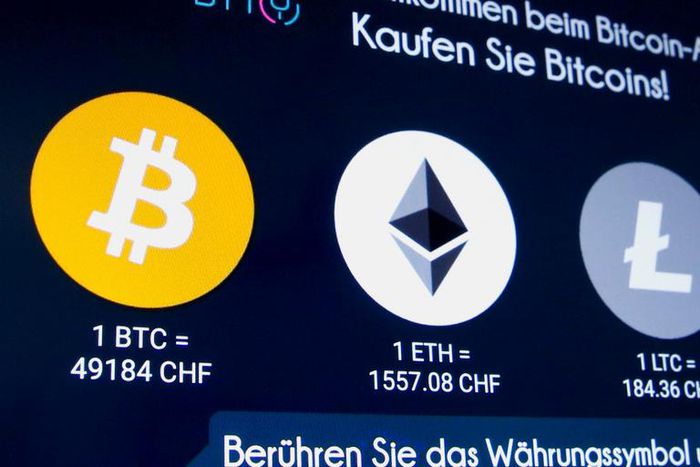 The exchange rates and logos of bitcoin, ether, litecoin, and monero are seen on the display of a cryptocurrency ATM of blockchain payment service provider Bity at the House of Satochi bitcoin and blockchain shop in Zurich, Switzerland, March 4, 2021.