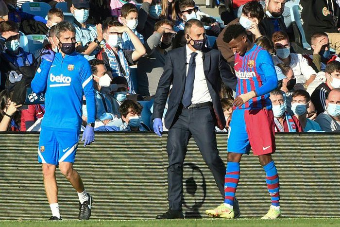 Barcelona's Spanish forward Ansu Fati  (right) limping off against Celta Vigo.