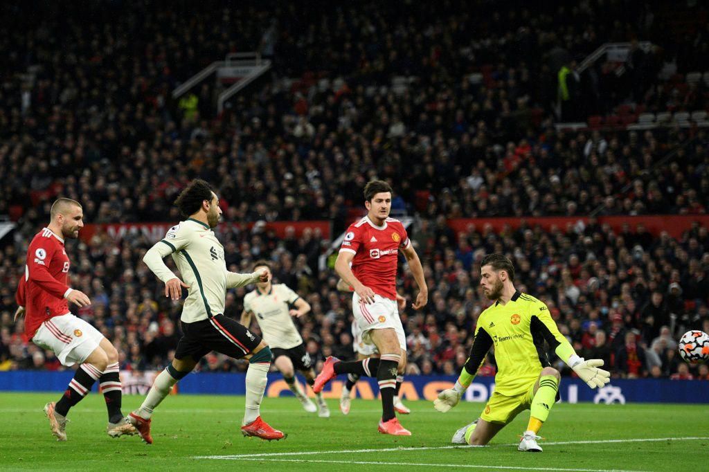 Liverpool forward Mohamed Saleh (2L) completes his hat-trick against Manchester United at Old Trafford on Sunday.
