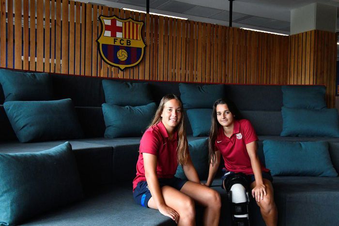Barcelona's women's B team players Claudia Riumallo Pineda (L) and Laura Coronado pose after a training session at the La Masia Residence