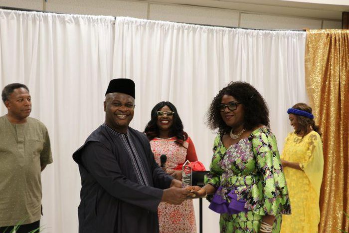 Consul-General of Nigeria in New York, Amb. Lot Egopija, presenting an award to Mrs Yemisi Oladele, Social Secretary, Consulate-General of Nigeria in New York at a conversation on way forward for Nigeria at the State of New Jersey, U.S. In the middle i...