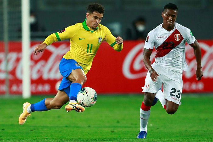 Philippe Coutinho takes on Peru's Pedro Aquino in a World Cup qualifier in October 2020, the Barcelona player's last appearance for Brazil