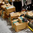 An employee handles packages at the Amazon's Bretigny-sur-Orge warehouse in France.
