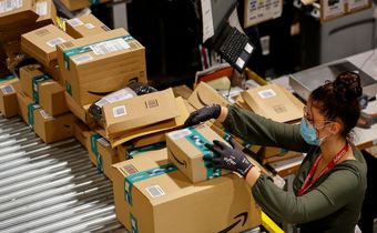An employee handles packages at the Amazon's Bretigny-sur-Orge warehouse in France.