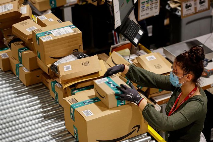 An employee handles packages at the Amazon's Bretigny-sur-Orge warehouse in France.