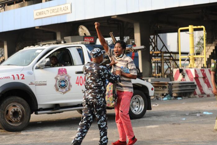 Police Task Force arresting a peaceful protester at the Lekki Toll Gate Plaza