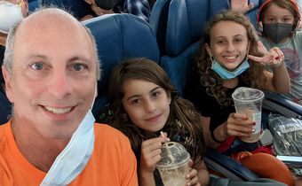 Author  Scott Tharler and his kids on a plane