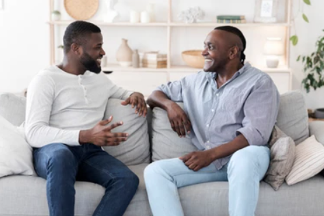 A photo of two men having a chat