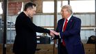 L-R: Elon Musk shakes hands with US President-elect Donald Trump back stage during a campaign rally at the Butler Farm Show grounds on October 05, 2024 in Butler, Pennsylvania. [Getty Images]