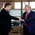 L-R: Elon Musk shakes hands with US President-elect Donald Trump back stage during a campaign rally at the Butler Farm Show grounds on October 05, 2024 in Butler, Pennsylvania. [Getty Images]
