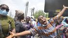 A woman react during a disgruntled faction of older women and Inspired group march with a banner during a walk demanding better government due to the recent hike in insecurity, hunger and inequality. [Getty Images]