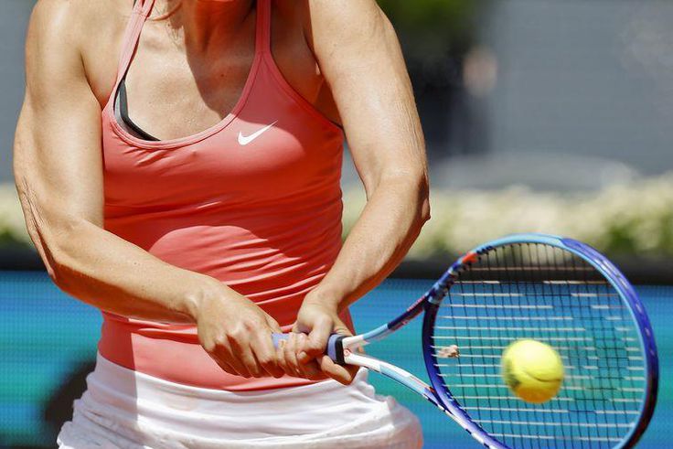 Maria Sharapova of Russia returns the ball to Caroline Wozniacki of Denmark during their match at the Madrid Open tennis tournament in Madrid, Spain, May 7, 2015. REUTERS/Andrea Comas