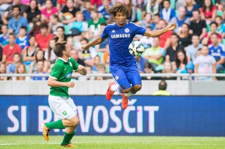 Chelsea's Dutch defender Nathan Ake (right) jumps for the ball during a friendly match against Olimpija Ljubljana on July 27, 2014 at the Stozice stadium in Ljubljana
