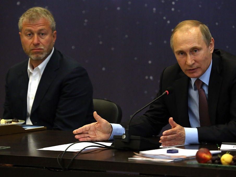 Russian President Vladimir Putin (right) speaks as billionaire and businessman Roman Abramovich (left) looks on during 2016 a meeting with top businessmen in Sochi, Russia.