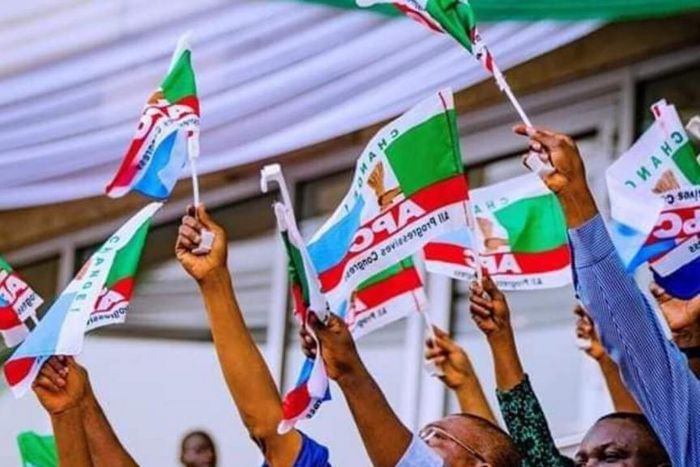 APC members holding party flag (PeoplesGazette)