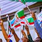APC members holding party flag (PeoplesGazette)