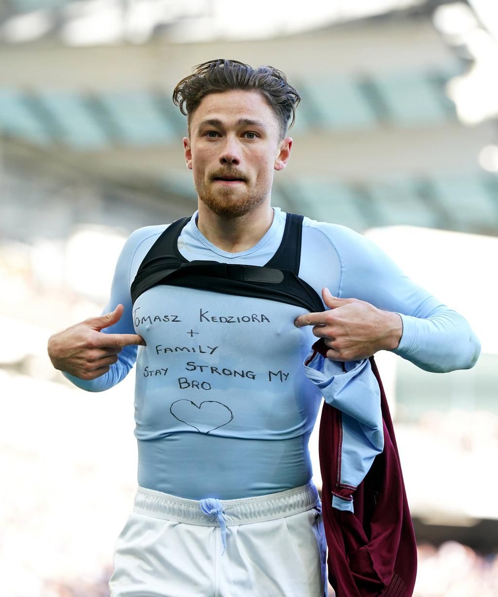 Matty Cash celebrates by revealing shirt supporting Poland team-mate Tomasz Kędziora
