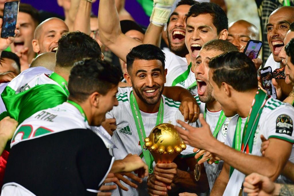 Captain Riyad Mahrez (C) holds the Africa Cup of Nations trophy after Algeria defeated Senegal in the 2019 final in Cairo