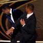 Will Smith, right, hits presenter Chris Rock on stage at the Oscars on Sunday, March 27, 2022, at the Dolby Theatre in Los Angeles.