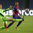 Bayern Munich goalkeeper Manuel Neuer (L) clears the ball against Barcelona.