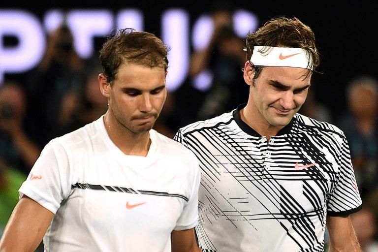 Roger Federer (R) with Rafael Nadal after their final at the Australian Open on January 29, 2017