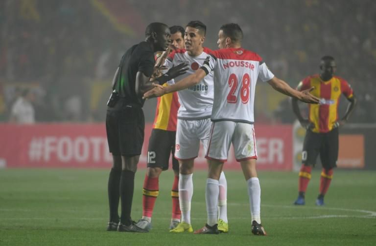 Wydad Casablanca captain Abdelatif Noussir (R) argues with Gambian referee Bakary Gassama after his side had a goal disallowed during the CAF Champions League final